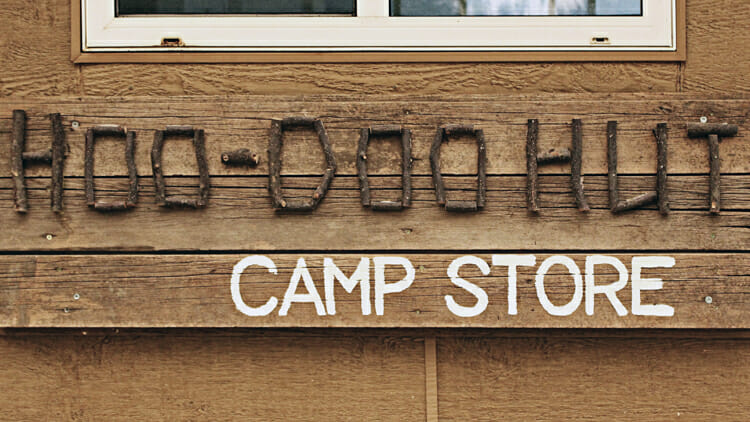 sign for camp store in writing on stone